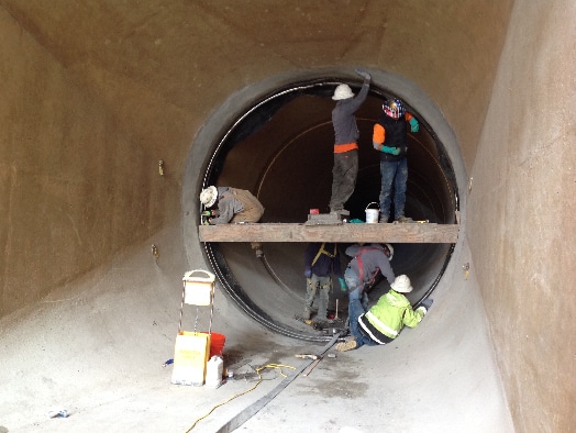 A HydraTite Seal being installed by multiple Field Services Technicians in a large diameter pipe
