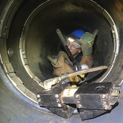 Field Service Technician in a small diameter pipe installing a HydraTite Seal