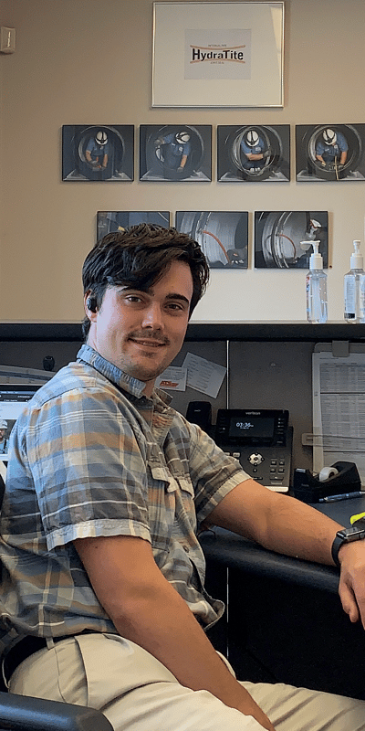 Office Administrator Caleb at his desk