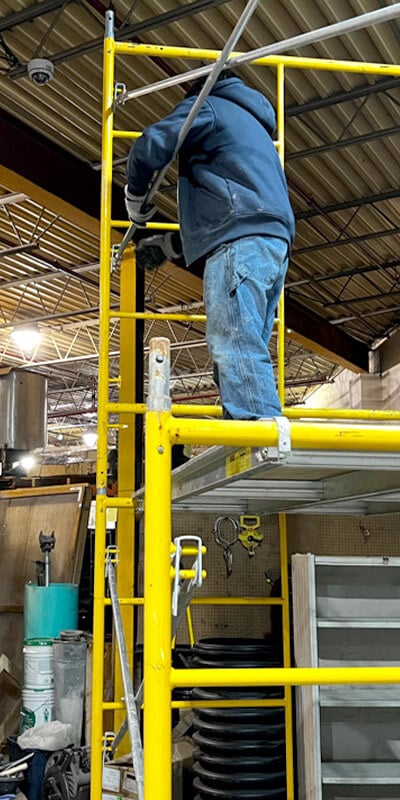 A technician building the Scaffolding