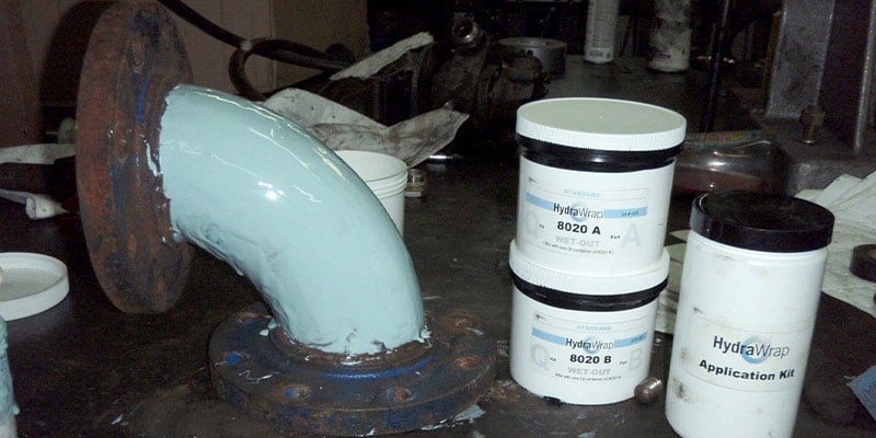 Elbow coated in primer for HydraWrap Installation
