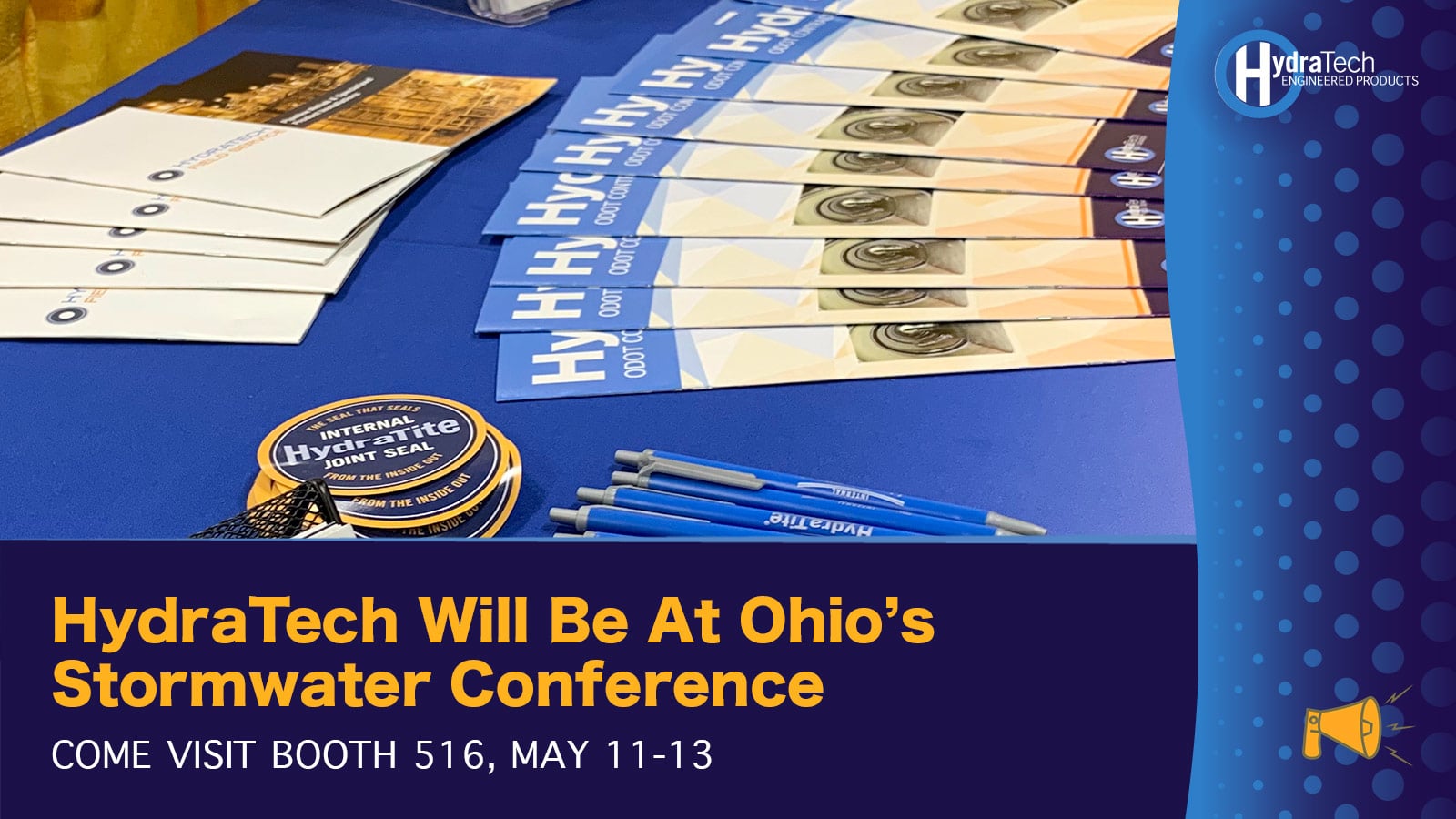 A table of trade show supplies for HydraTech, 'HydraTech Will Be At Ohio's Stormwater Conference, Come Visit Booth 516, May 11-13'