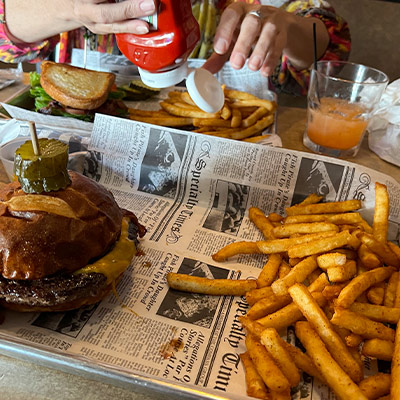 Burger and fries on a platter on a table