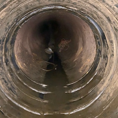 The dirty interior of a pipe in which the joint has been sealed with HydraTite