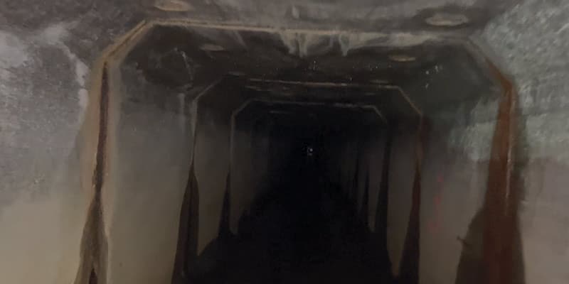Inside a dark box culvert in which the joints are leaking