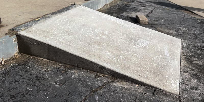 Concrete ramp to let the forklifts go up and down a step
