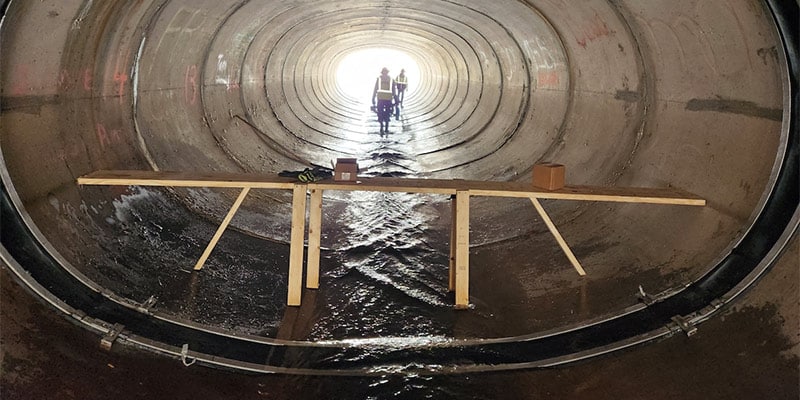 HydraTite installed over a joint in an elliptical culvert. A stand in the center holding tools.