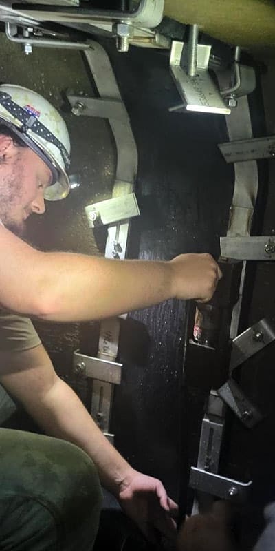 A field technician installing HydraTite in a box culvert. Expanding a retaining band.