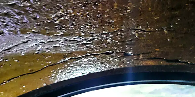 cracks running through a pipe's surface near a HydraTite seal