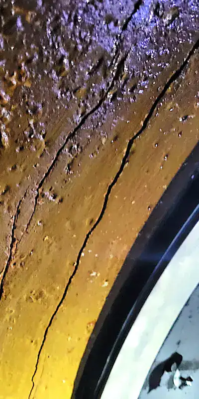 cracks running through a pipe's surface near a HydraTite seal