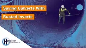 Technician spreading concrete on the invert of a pipe