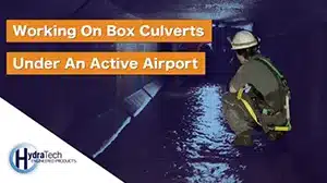 Technician crouching in a box culvert
