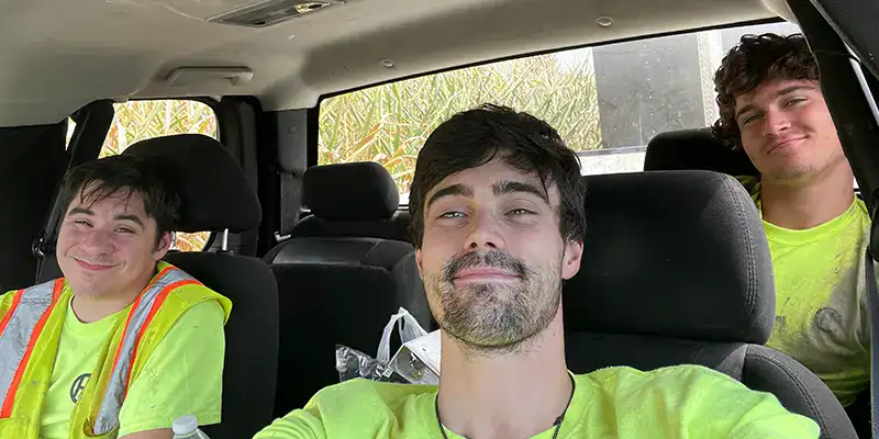 Three technicians taking lunch in a truck