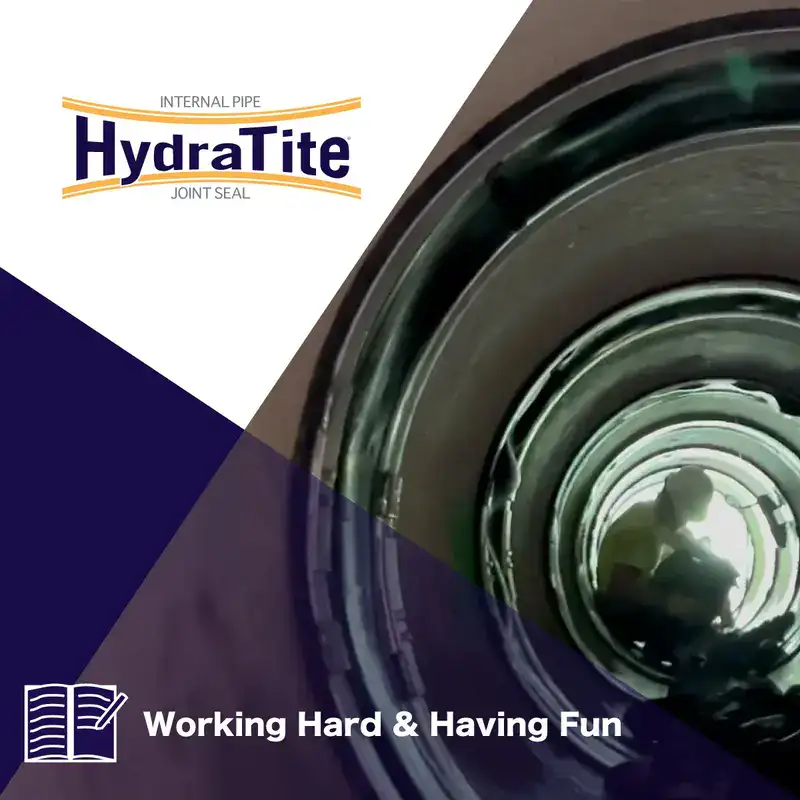 A technician sitting in a pipe that has had HydraTite installed over a joint, 'Working Hard & Having Fun'