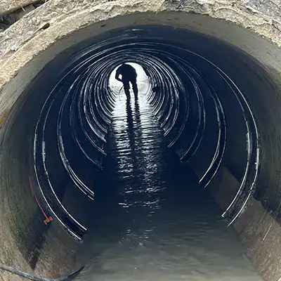 Joint with an active leak in a green PVC pipe