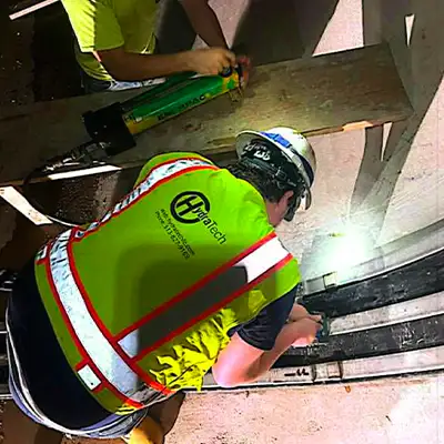 Two technicians installing HydraTite in a large diameter pipe