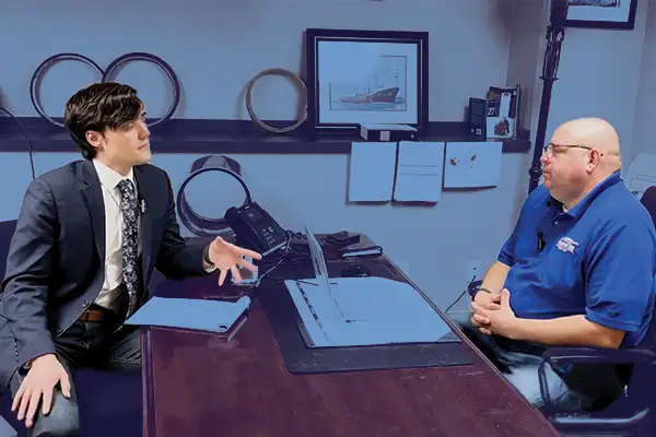 Two people talking at a desk
