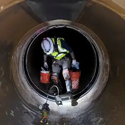 Technician walking through a pipe