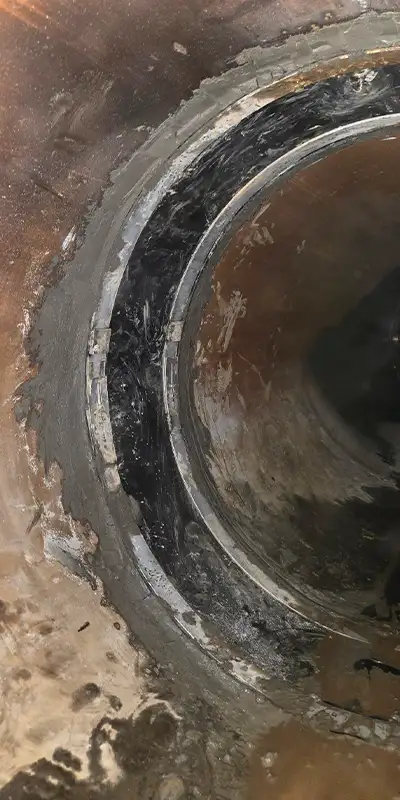 Retaining bands sitting at the invert of a pipe near the joints