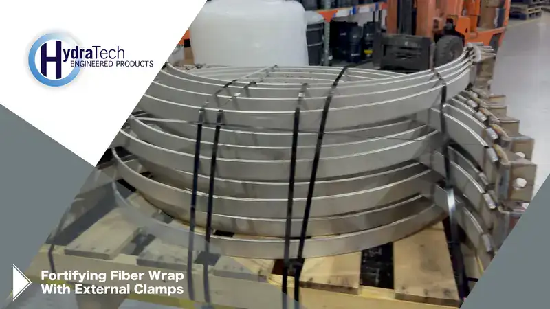 A stack of steel on a shipping pallet, 'Fortifying Fiber Wrap With External Clamps"