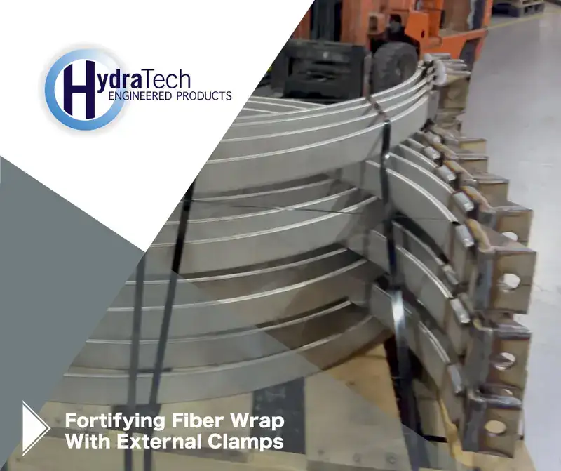 A stack of steel on a shipping pallet, 'Fortifying Fiber Wrap With External Clamps"