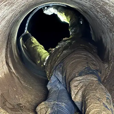 A Technician Installing A Seal In A Small-Diameter Pipe2 Technician walking through a pipe