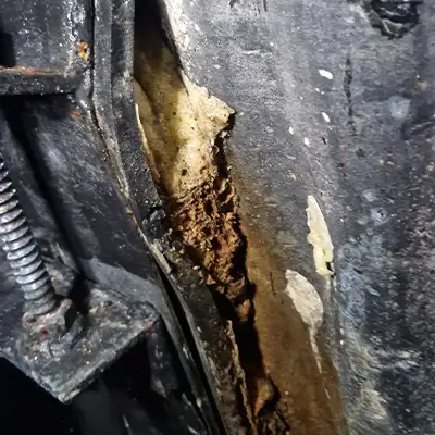 Failing pipe repair that has buckled and begun to fall away from the host pipe