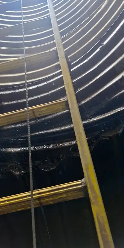 A ladder leading out of a corrugated pipe