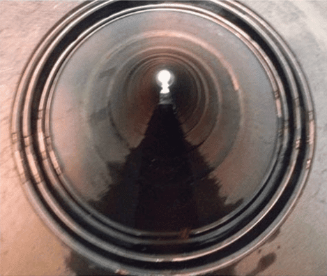 A HydraTite seal installed in a pipe with four steel retaining bands
