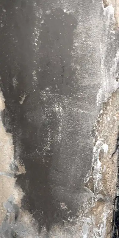 A patch of concrete on the interior of a pipe