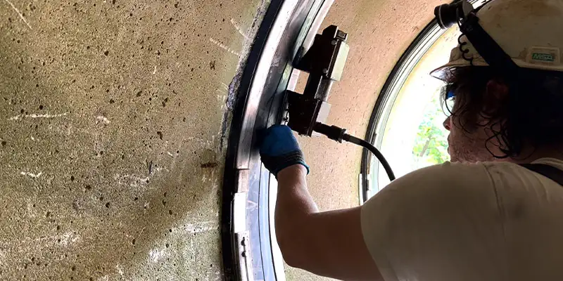 Technician inserting a wedge behind a stainless steel retaining band