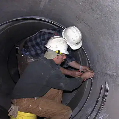 technicians constructing a retaining band for a HydarTite seal