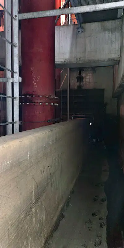 The view of someone standing near an entry point to a pipe