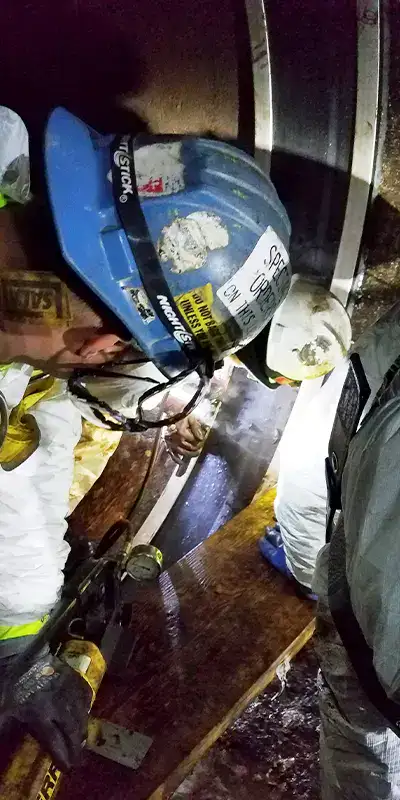 Several technicians installing HydraTite in a large diameter pipe