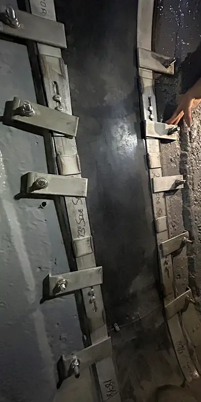 A HydraTite seal installed over a joint with hold-downs and anchors to ensure proper pressure