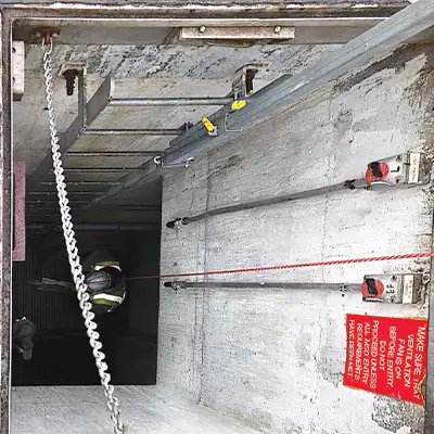 Looking down into a pipe at a technician