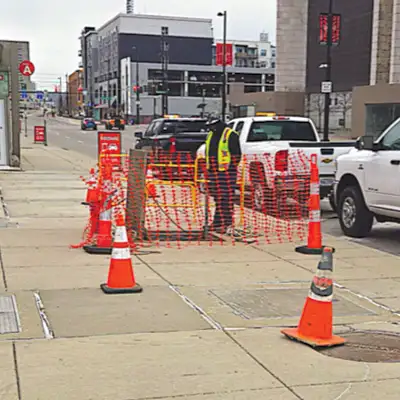 A technician sending watch near a pipe entry point