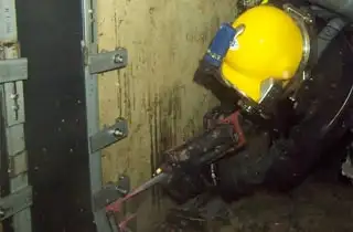 A Diver Applying Epoxy To The Outer Edge Of The HydraTite Seal Installed In A Submerged Box Culvert