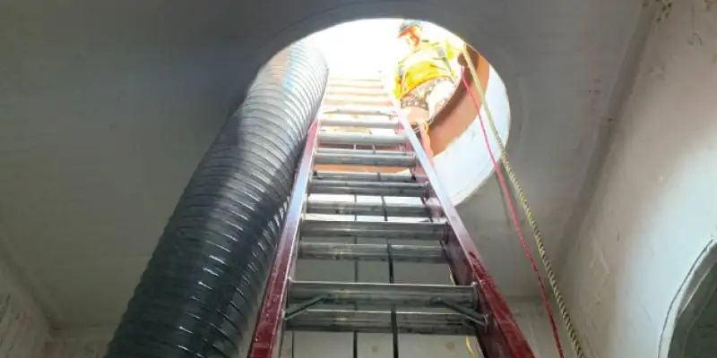 A ladder leading out of a pipe