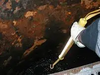 A hand reaching down into a pipe