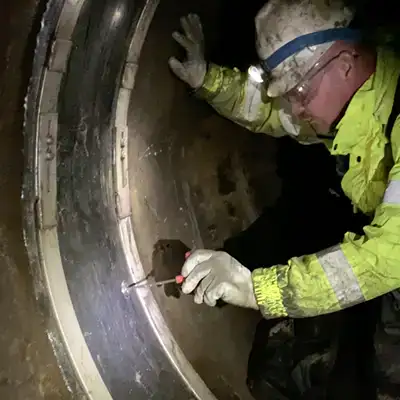 A technician opening an air test valve