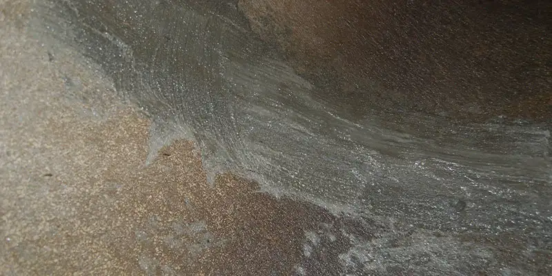 A portion of the interior surface of a pipe that has been smoothed out with concrete