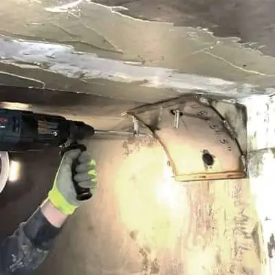 A technician installing a corner form in a box-shaped flume