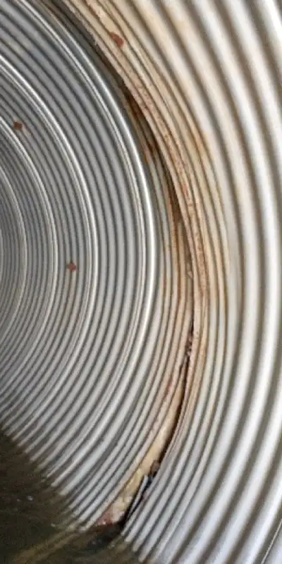 A separated joint in a corrugated metal pipe