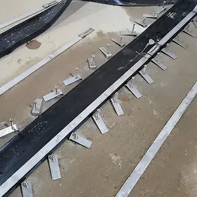 HydraTite component being positioned over a joint in a basin