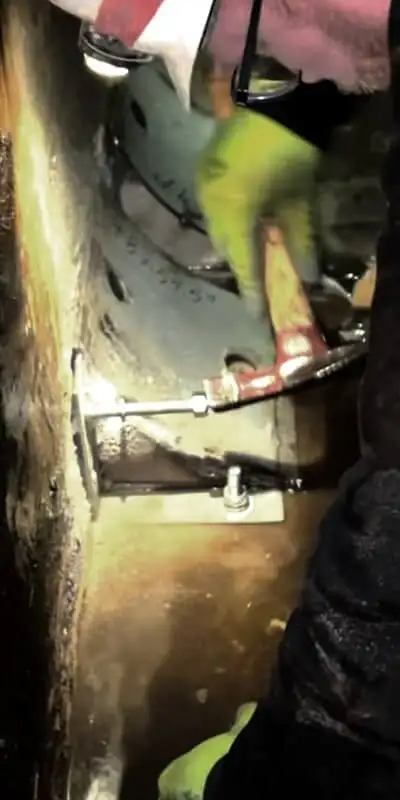 A technician installing a corner form in a box-shaped flume