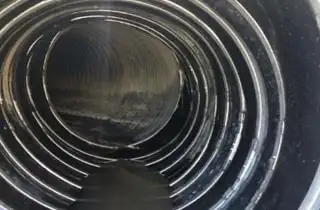 A sleeve of HydraTite seals installed over a large damaged portion of a pipe interior