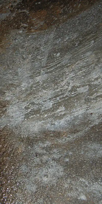 A portion of the interior surface of a pipe that has been smoothed out with concrete