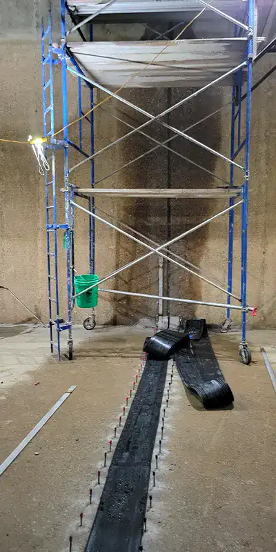 Scaffolding being used to install HydraTite over a joint in a large water basin