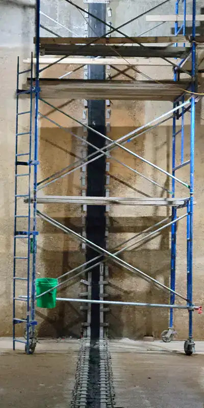 Scaffolding being used to install HydraTite over a joint in a large water basin